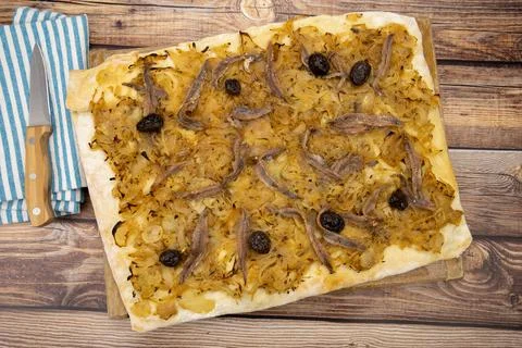 Rectangular pissaladière pie on a wooden table 스톡 사진