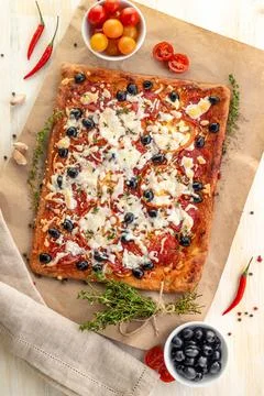Rectangular Pizza with sausage, black olives and cheese. Stock Photos