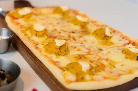 Rectangular Pizza with Sweet Pumpkin Topping and Cheese on a Wooden Board Stock Photos