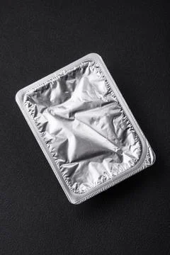 Rectangular plastic box with yogurt or cheese hermetically sealed with a fo.. Stock Photos