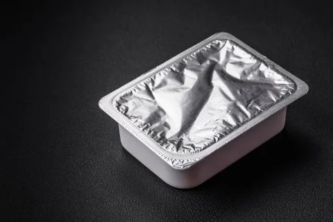 Rectangular plastic box with yogurt or cheese hermetically sealed with a f... Foto stock