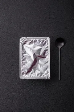 Rectangular plastic box with yogurt or cheese hermetically sealed with a foil Foto stock