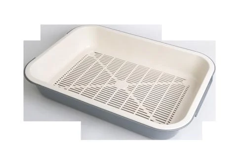 Rectangular plastic cat litter box with white grid for easy cleaning and hygiene Stock Photos