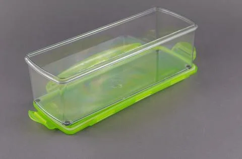 Rectangular plastic container with lid for food storage on gray background. Stock Photos