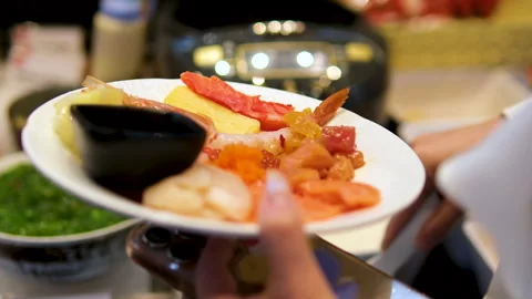 A rectangular plate of assorted sushi, including nigiri, sashimi, and tamago Stock Footage 323532604