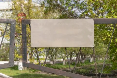 Rectangular plate on a closed metal gate. 写真素材