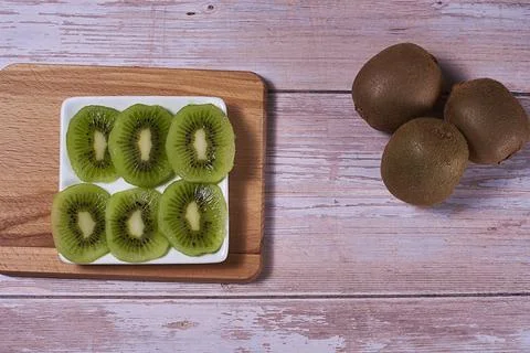 Rectangular plate with cut kiwi Stock Photos