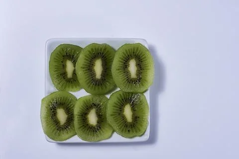 Rectangular plate with cut kiwifruit Stock Photos