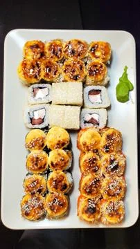 Rectangular plate full of hand-rolled sushi, sushi set, close-up Stock Photos