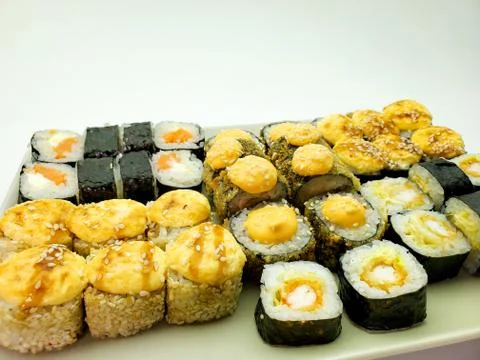 Rectangular plate full of hand-rolled sushi, sushi set, close-up Stock Photos