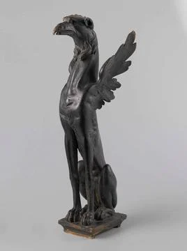 . On a rectangular plinth, the griffin formed from an elongated dog body w... 库存照片