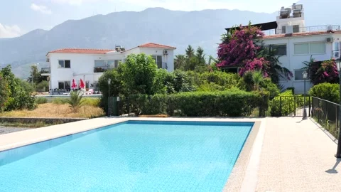 Rectangular pool with blue turquoise water and a private house villa. Stock Footage 130516393