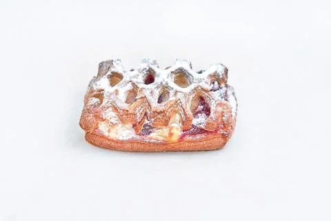 Rectangular puff pastry filled with jam. Closeup on a light background Stock Photos