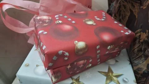Rectangular red christmas gift box wrapped in festive holiday paper Stock Photos