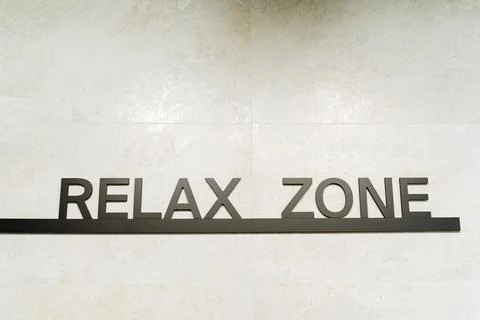 Rectangular relax zone sign with artistic font and graphics on a wall, poss.. Foto stock