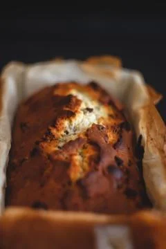 Rectangular ruddy metropolitan cake-bread in a metallic baking dish on a dark Stock Photos