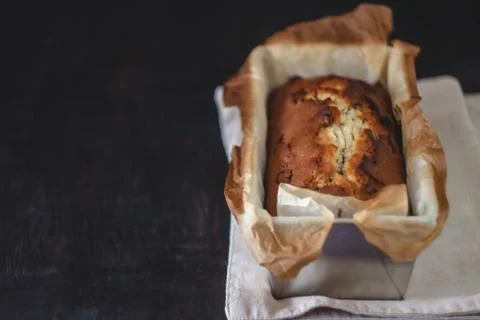 Rectangular ruddy metropolitan cake-bread in a metallic baking dish on a dark Foto stock