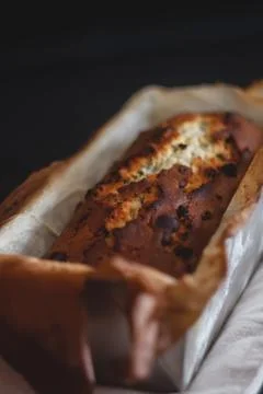 Rectangular ruddy metropolitan cake-bread in a metallic baking dish on a dark Stock Photos