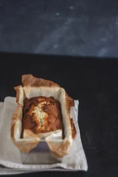 Rectangular ruddy metropolitan cake-bread in a metallic baking dish on a dark Foto stock