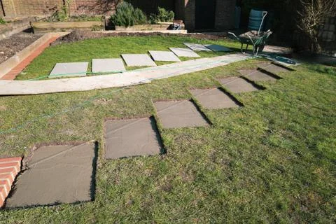 Rectangular sections cut into a lawn with concrete bases Stock Photos