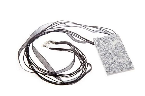 Rectangular shape white and black necklace isolated on white background. Stock Photos