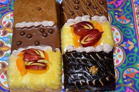 Rectangular shaped birthday cake of 3 parts of different pieces sponge crea.. Stock Photos