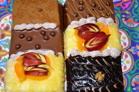 Rectangular shaped birthday cake of 3 parts of different pieces sponge crea.. Stock Photos