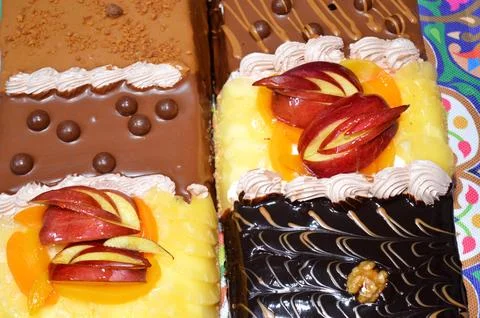 Rectangular shaped birthday cake of 3 parts of different pieces sponge crea.. Stock Photos