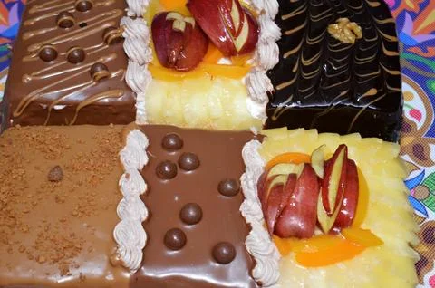 Rectangular shaped birthday cake of 3 parts of different pieces sponge crea.. Stock Photos