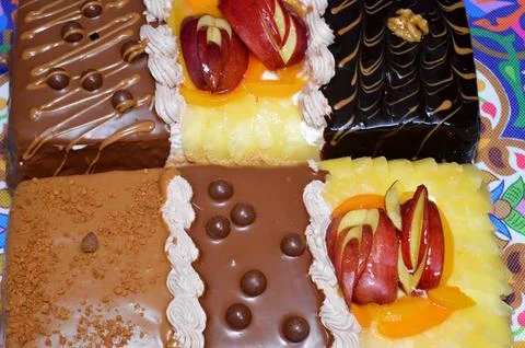 Rectangular shaped birthday cake of 3 parts of different pieces sponge crea.. Stock Photos