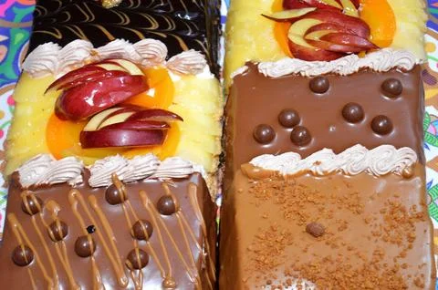 Rectangular shaped birthday cake of 3 parts of different pieces sponge crea.. Stock Photos