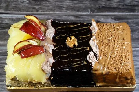 Rectangular shaped birthday cake of 3 parts of different pieces sponge crea.. Stock Photos