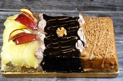 Rectangular shaped birthday cake of 3 parts of different pieces sponge crea.. Stock Photos