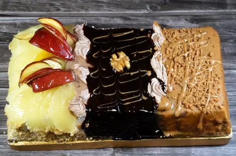 Rectangular shaped birthday cake of 3 parts of different pieces sponge crea.. Stock Photos