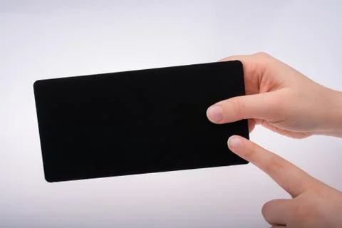 Rectangular shaped black notice board in hand Stock Photos