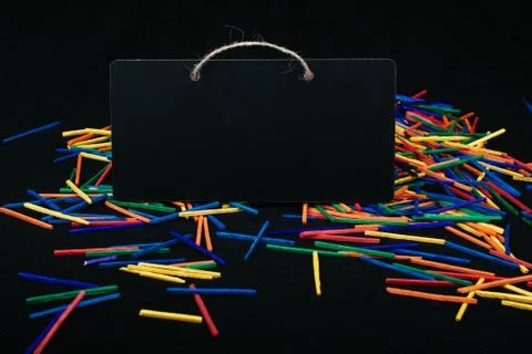 Rectangular shaped black notice board on colorful sticks Stock Photos