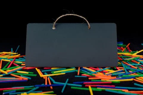 Rectangular shaped black notice board on colorful sticks Stock Photos