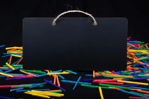 Rectangular shaped black notice board on colorful sticks Stock Photos