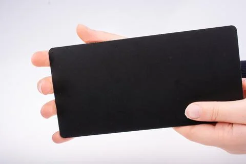 Rectangular shaped black notice board in hand 写真素材