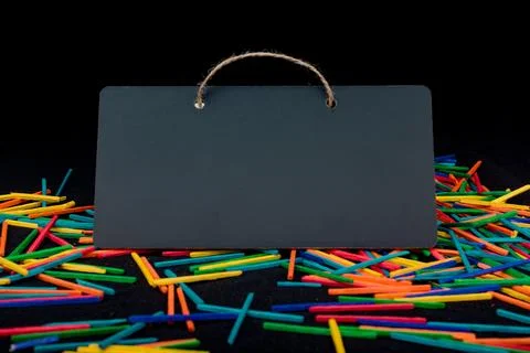 Rectangular shaped black notice board on colorful sticks Stock Photos