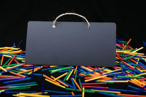 Rectangular shaped black notice board on colorful sticks Stock Photos