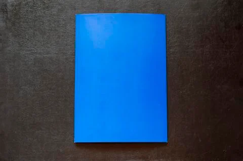Rectangular sheet of blue paper on a black background. Stock Photos