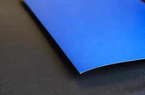 Rectangular sheet of blue paper on a black background. Stock Photos