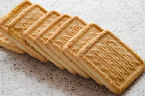 Rectangular shortbread cookies on a light marble top. Homemade baking. Stock Photos