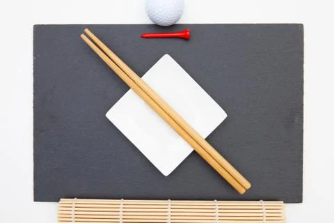 Rectangular slate plate with chopsticks for sushi and golf tee. 스톡 사진