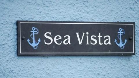 A rectangular slate tile with house name Sea Vista near Tenby harbour 스톡 사진
