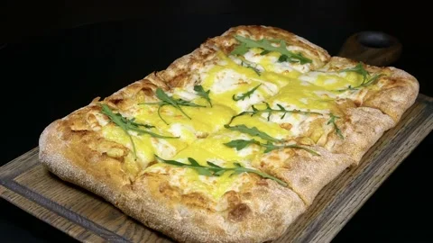 Rectangular sliced roman pizza lying on a wooden tray Stockbeeldmateriaal 141968886