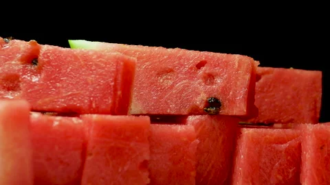 Rectangular slices of watermelon spinning on a black background close-up. Stockbeeldmateriaal 161083426