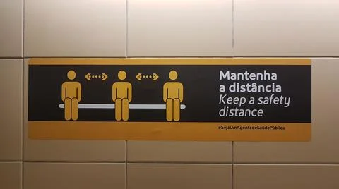 Rectangular sticker on the floor in Portuguese meaning "Keep a safety distanc 스톡 사진