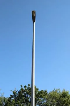 A rectangular street lamp, blue sky in the background Stock Photos